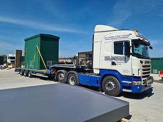 A Scania truck is pulling a green container