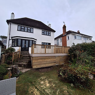 Custom timber decking and balustrade installed at the rear of a residential property