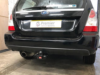 Close-up of the rear bumper of a black Subaru Forester with a fixed Witter tow bar fitted