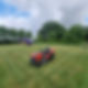 ride-on lawnmower and a helicopter on a large green lawn