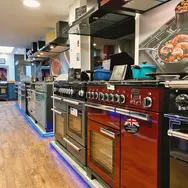 Kitchen showroom display featuring premium red range cooker