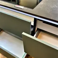 Open kitchen drawer with storage compartments in modern cabinetry
