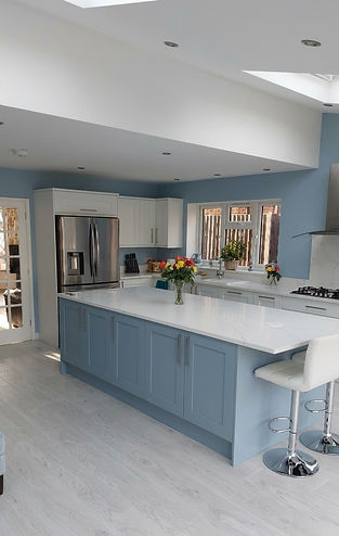 Contemporary kitchen renovation with pale blue cabinets and a large island