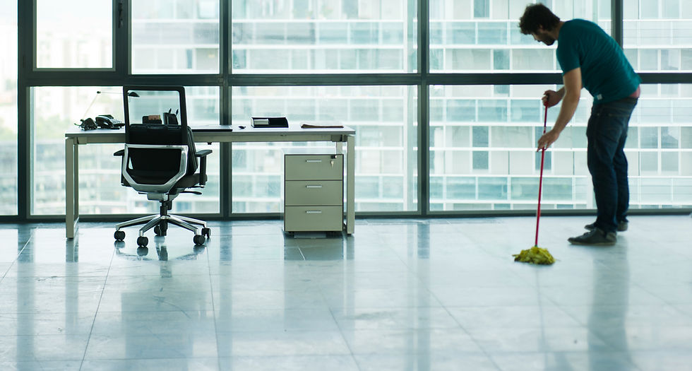 Office cleaner mopping a floor in a modern workspace