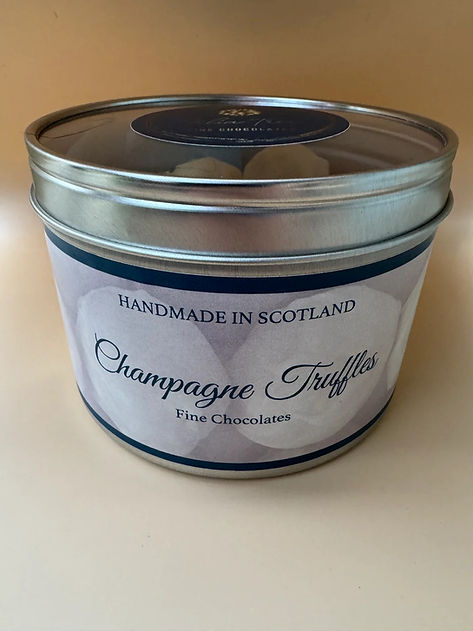 Round silver tin of handmade champagne truffles with custom label