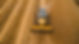 Aerial view of a yellow combine harvester working in a golden cereal field