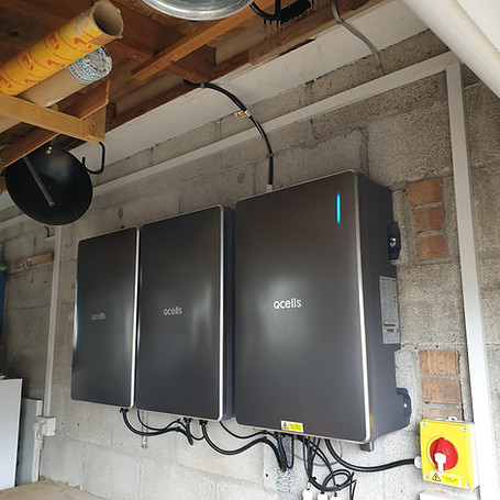 Three sleek, wall-mounted grey battery storage units