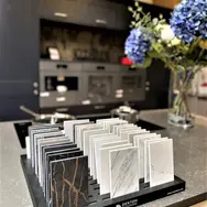 Stylish kitchen seating area with glass table and decorative plant