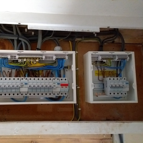 Two electrical circuit breaker panels with multiple wires and switches