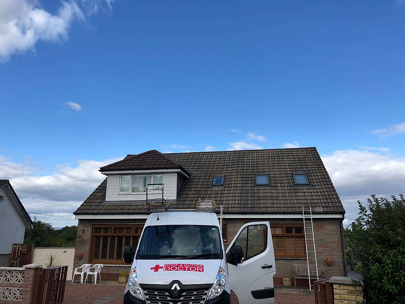 Roof & Gutter Doctor branded white Renault service van parked in a residential driveway