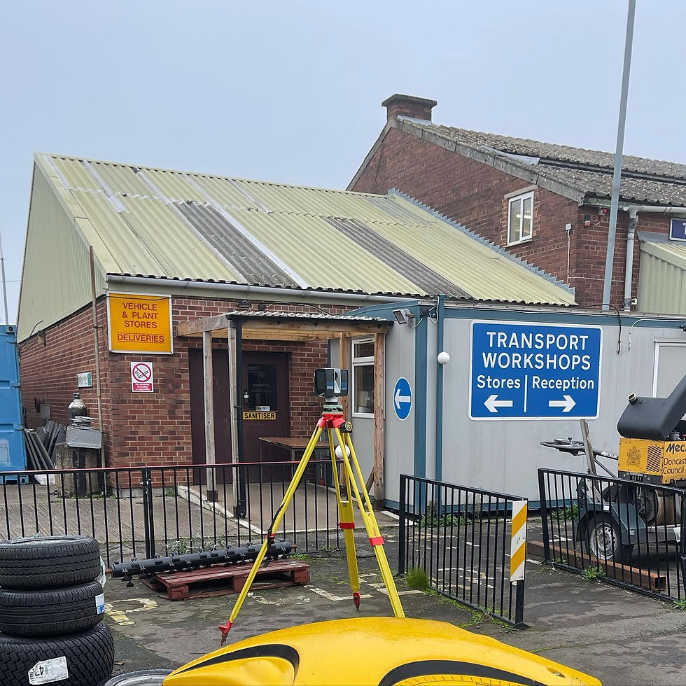 Laser scanner tripod set up outside commercial transport workshop facility