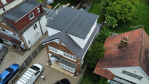 Aerial view of a hip-to-gable loft conversion on a detached house with new grey tile roofing