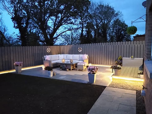 Warm outdoor lighting feature illuminating modern patio garden at night
