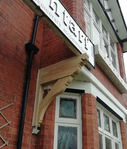 Decorative timber gallows bracket on a shop building