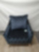 Blue patterned upholstered armchair with matching cushion