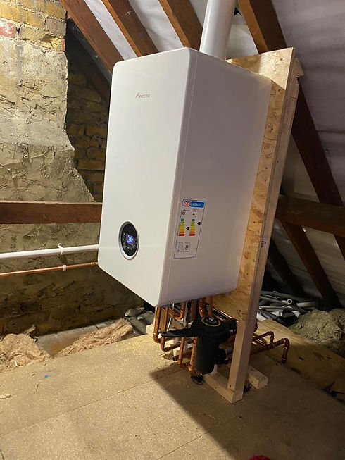 Worcester Bosch gas boiler installation on a wooden frame in a loft attic space