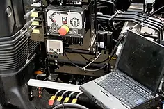 Close-up of industrial machinery with control panels featuring buttons and dials