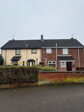 Front view of semi-detached houses with moss on the roof tiles