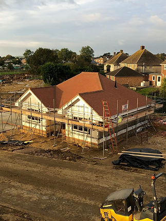 Full re roofing project with scaffolding on residential building