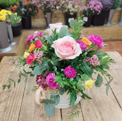 Pink and white rose bouquet in a glass vase