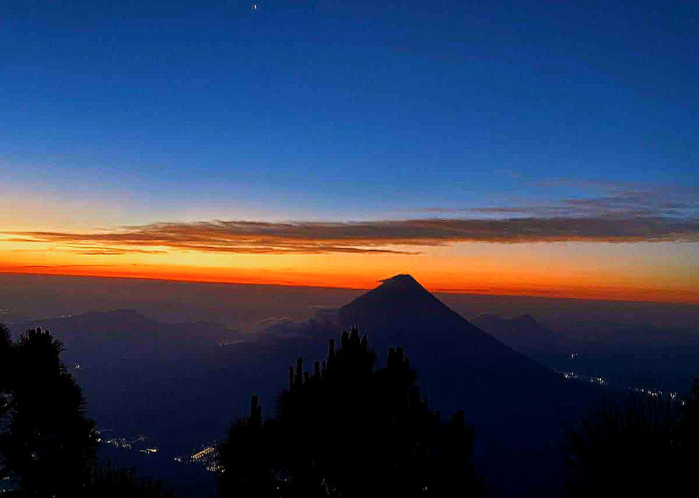 Sunset paints the sky above Antigua Guatemala, capturing a tranquil moment that embodies Gali's deep affection for this beautiful land.