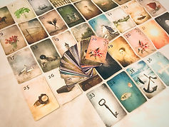 Collection of illustrated oracle cards spread on a table