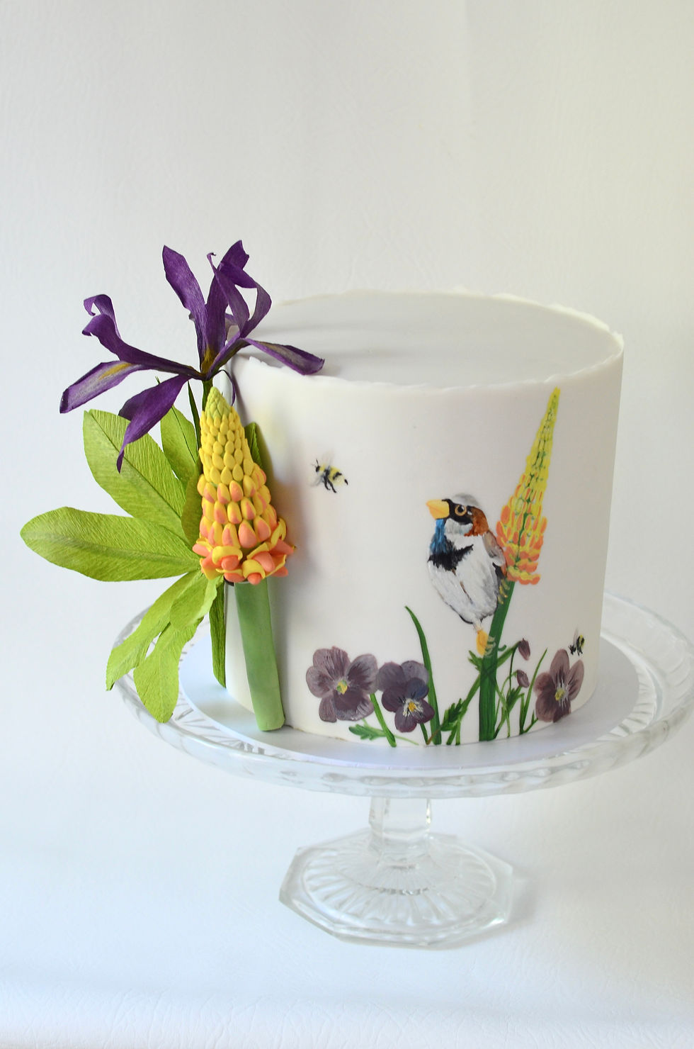 Painted bird and flowers on a white cake