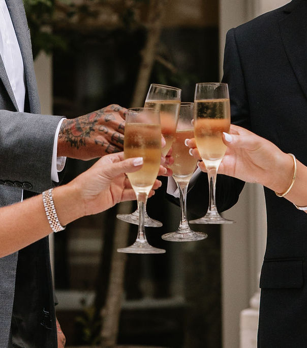 Engaged couple and friends toasting with champagne