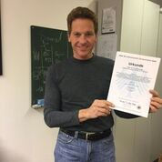 Dr King inventor investor holding one of his patents