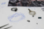 The ring hand-sketch, sample, gems, and final cut jewelry.