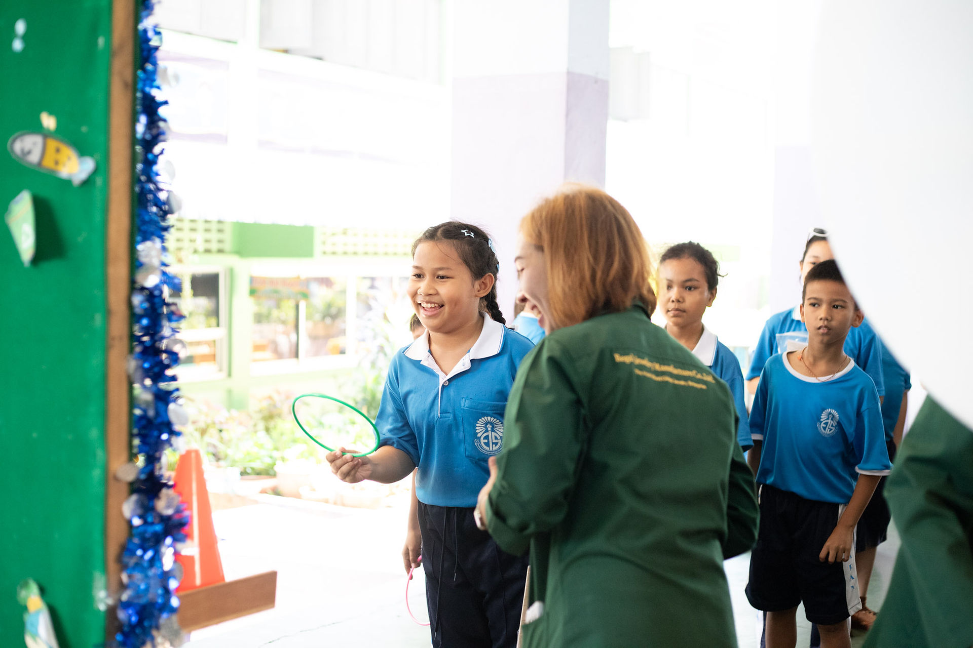 Girl laughing while playing hoops throwing game.