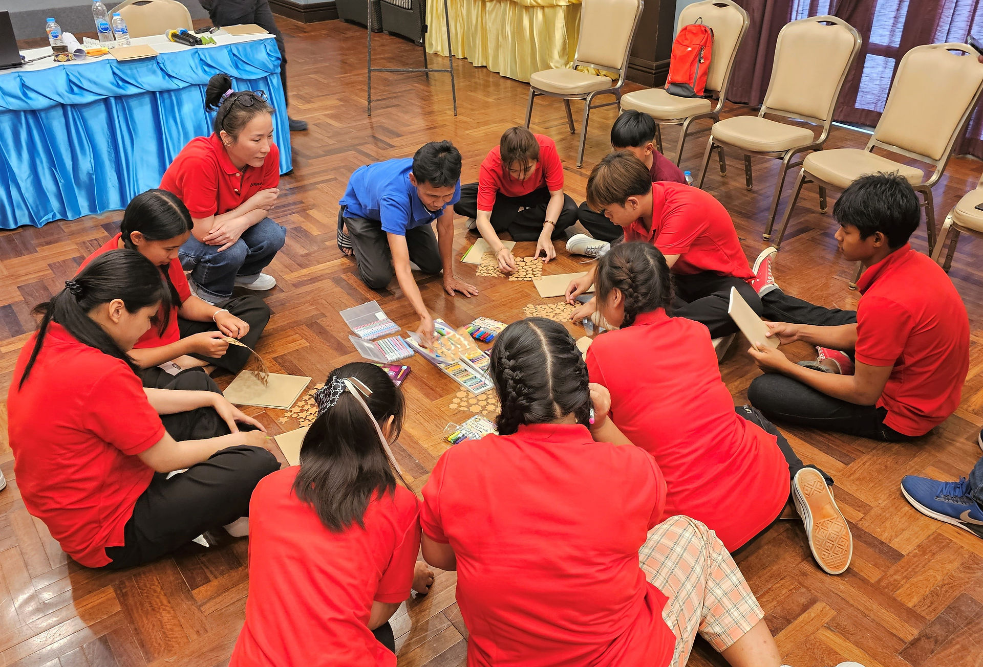 Regal Jewelry's CEO doing group activity with students.
