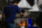 Staff heating a metal mold with fire.