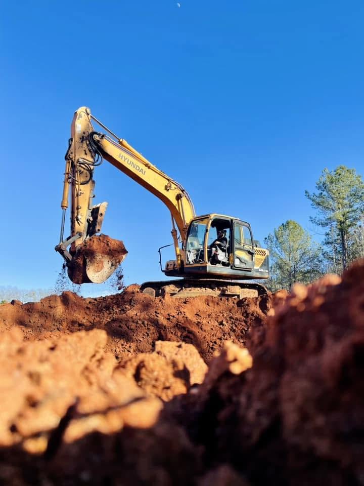 Excavator digging red Georgia clay on an excavation job