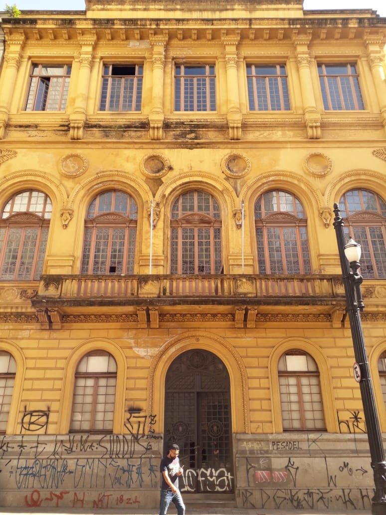 Big Classic Building, windows, doors and a person walking