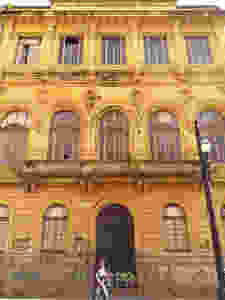 Big Classic Building, windows, doors and a person walking