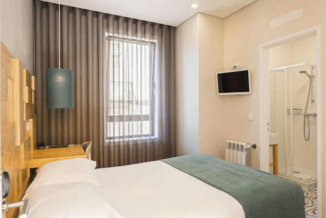 Bedroom with double bed, desk and bathroom