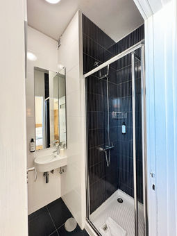 Bathroom with shower and sink.