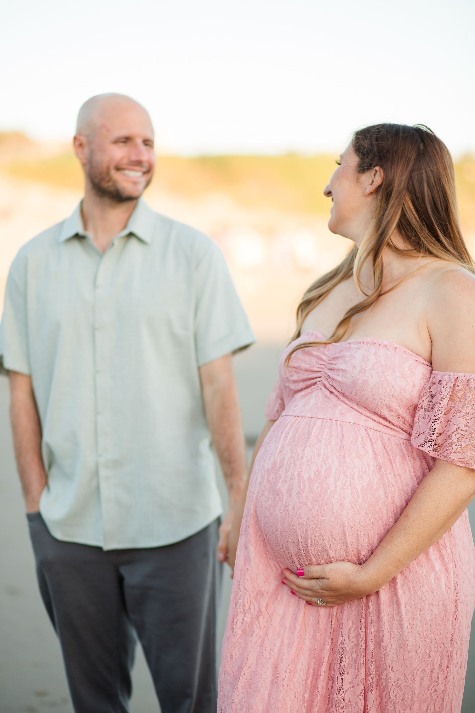 hkcreate bay area photography joyful light and airy san jose photographers northern california photoshoot beach maternity session pink lace dress natural bridges state beach santa cruz couple looking at each other