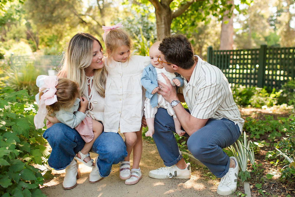 Family of four with two young children crouches in a sunny garden, smiling and cuddling.
Spring Family Photoshoot at Elizabeth Gamble Garden, Palo Alto by Bay Area Photographers HKCreate