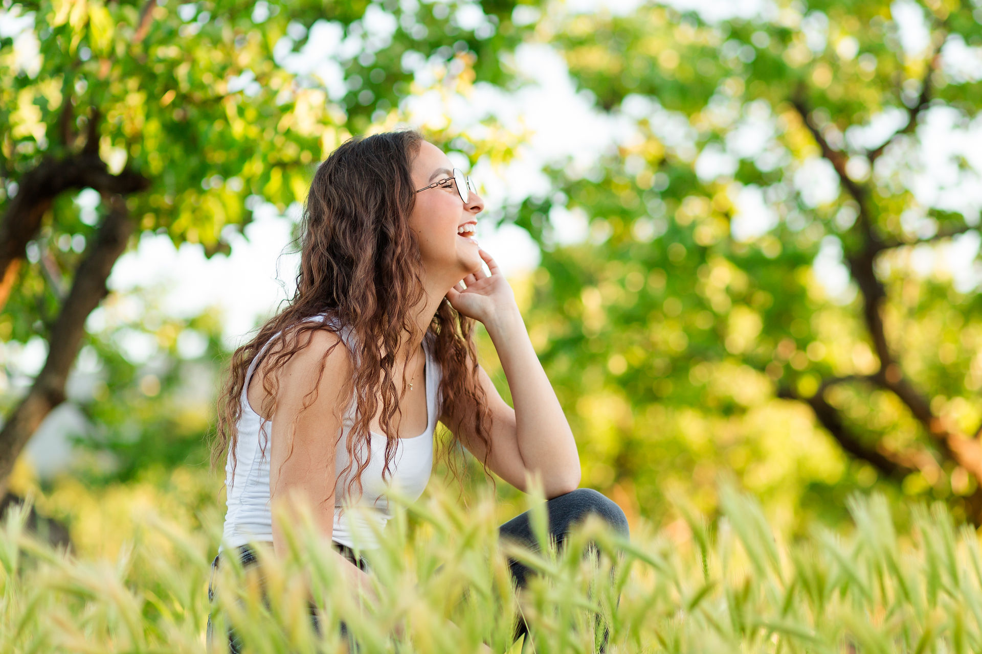 hkcreate bay area photography san jose photographers heritage orchard saratoga library high school graduation photoshoot beautiful golden hour graceful bloom session with flowers whimsical joyful happy light and airy northern california casual outfit white shirt gray black jeans mustard yellow flowers portrait tall grass