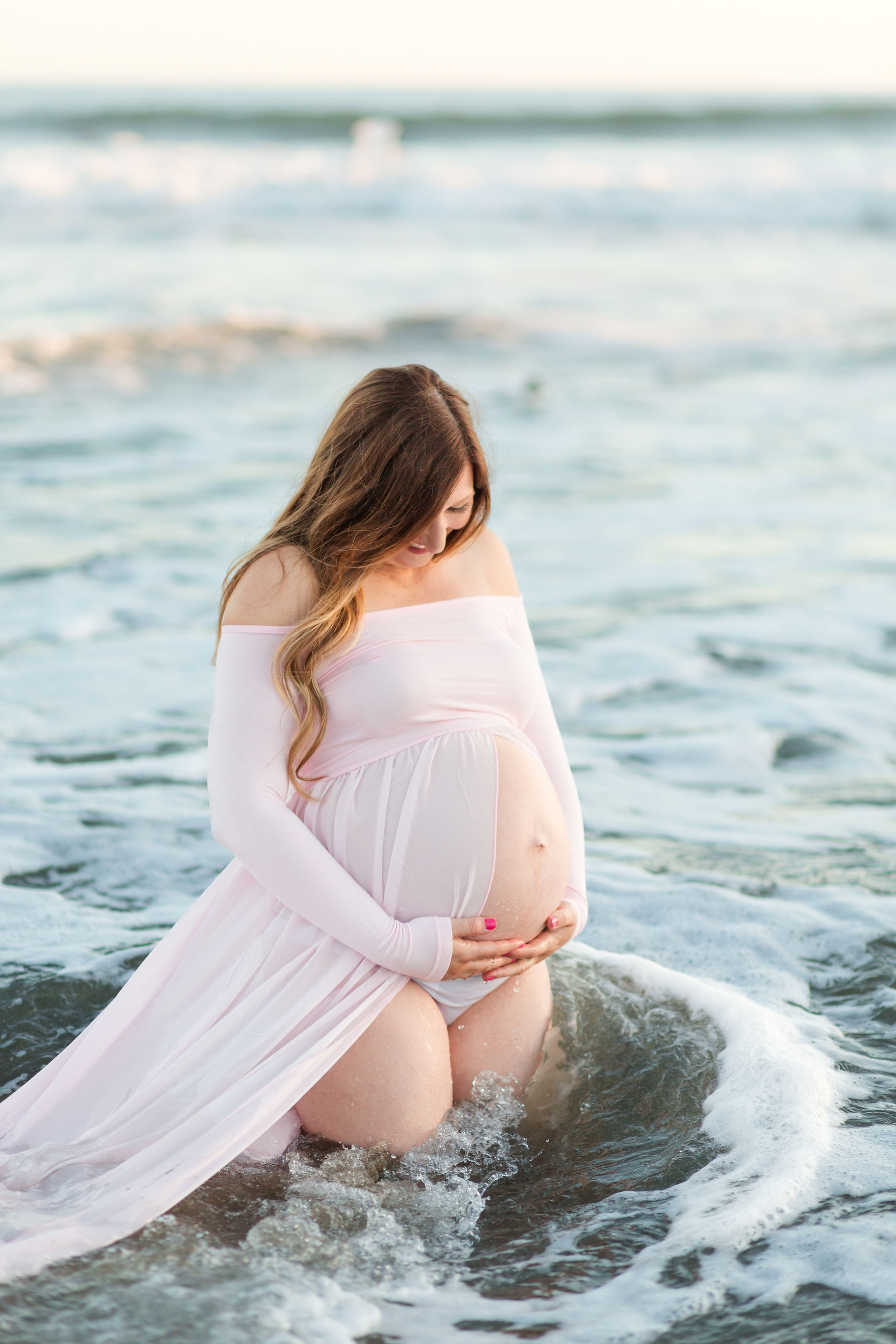 hkcreate bay area photography joyful light and airy san jose photographers northern california photoshoot beach maternity session pink belly dress natural bridges state beach santa cruz ocean sunset kneeling in water white bikini