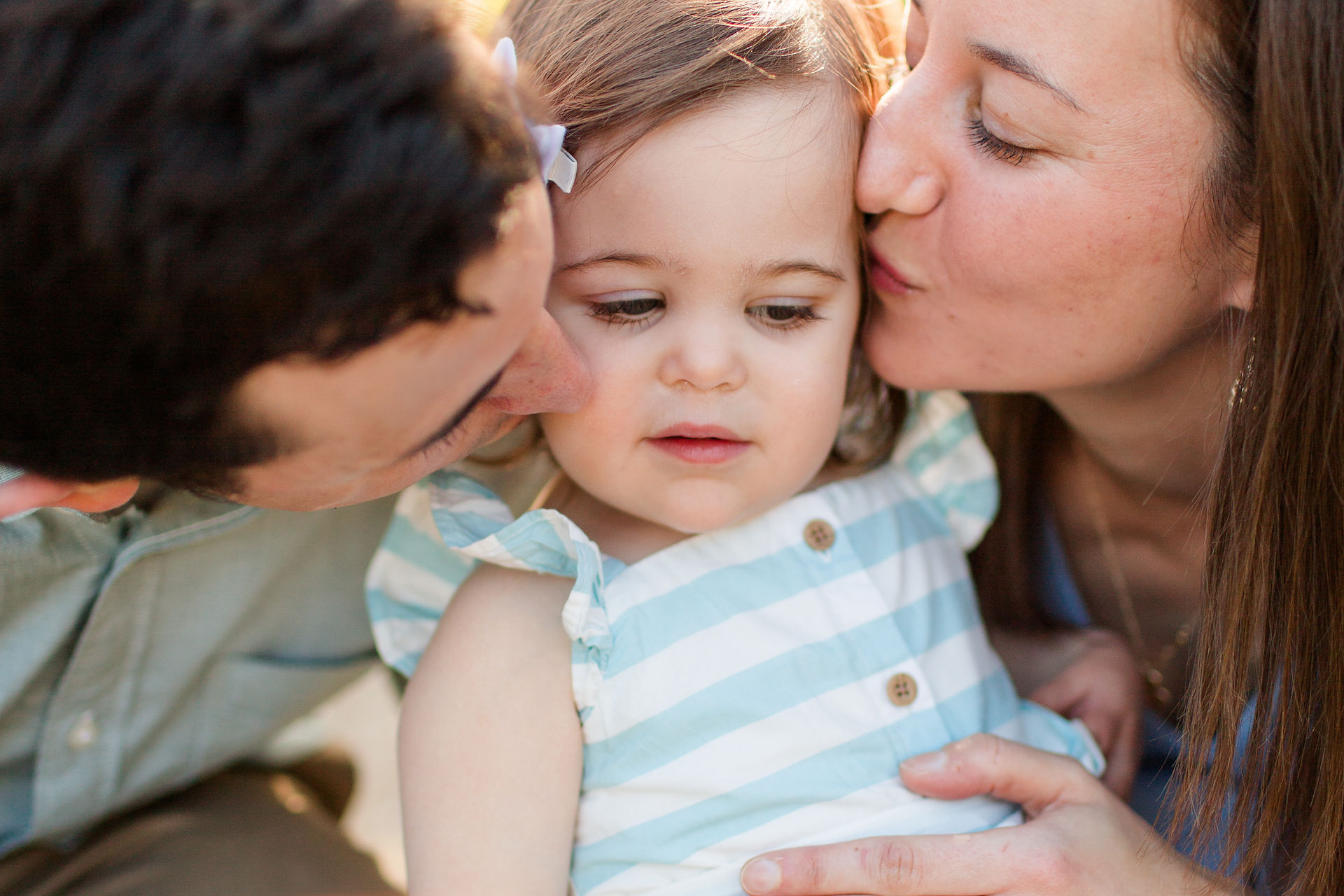 hkcreate bay area photography joyful light and airy san jose photographers northern california photoshoot spring family of three toddler girl baby blue striped dress outfit ideas gamble garden palo alto kissing cheeks close up