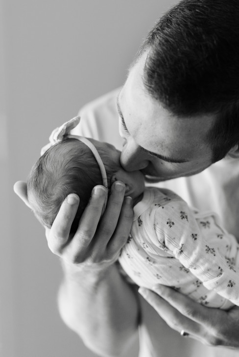hkcreate bay area photography joyful candid light and airy lifestyle newborn photoshoot san jose photographers neutral colors pink cream baby girl dad kissing baby cheek black and white