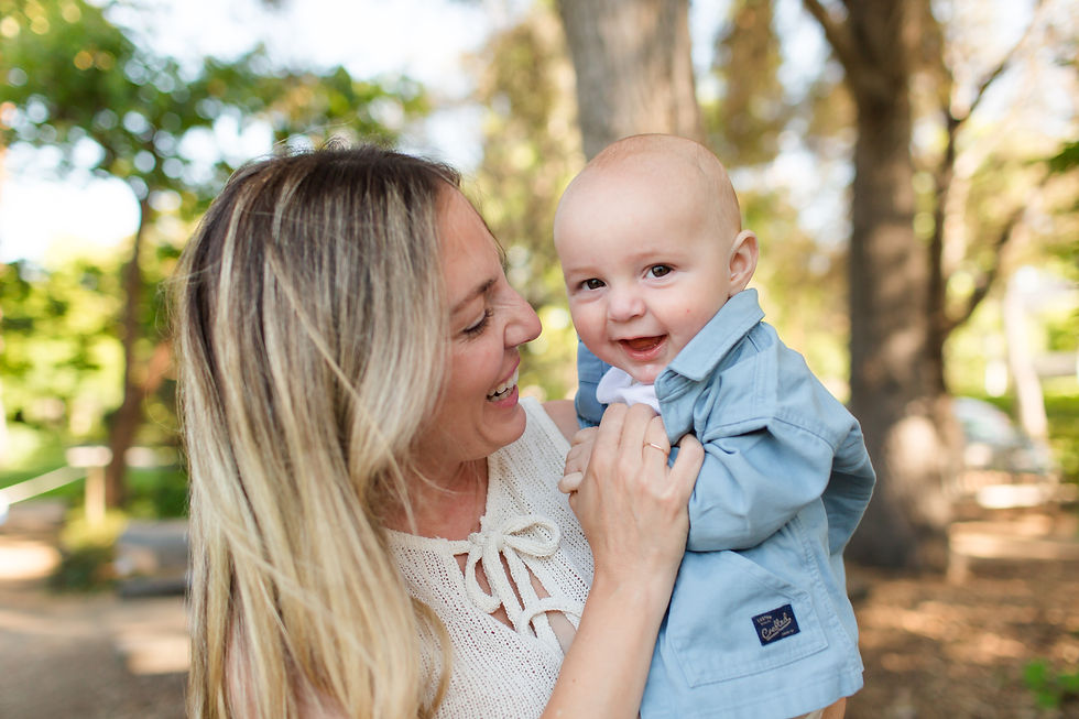 Smiling woman holds laughing baby in a light blue shirt outdoors with trees and soft sunlight in the background.
Spring Family Photoshoot at Elizabeth Gamble Garden, Palo Alto by Bay Area Photographers HKCreate