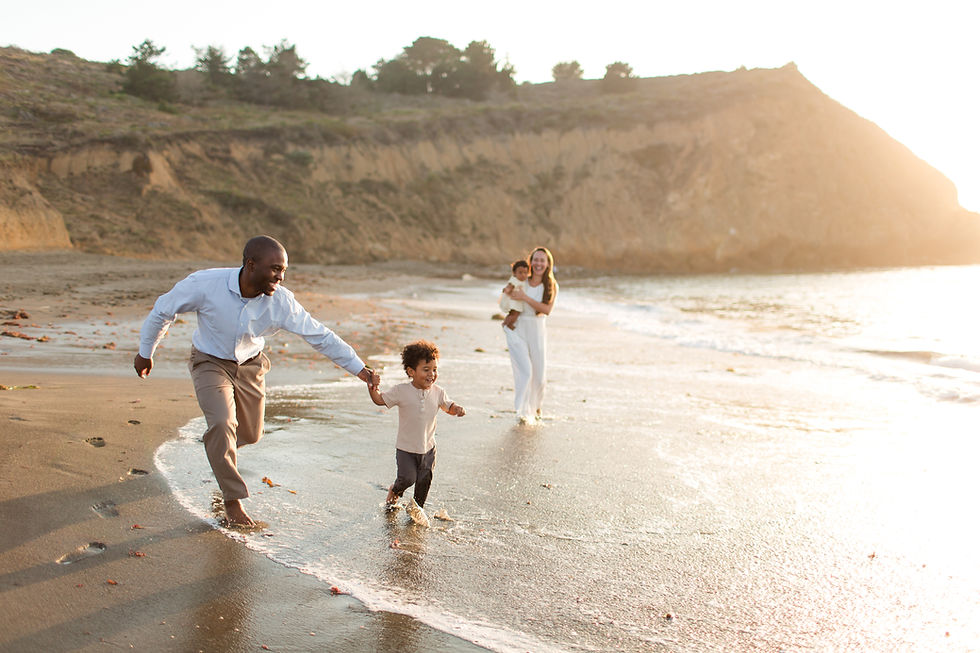hk create bay area photography family running on beach having fun laughing neutral outfits baby toddler biracial couple