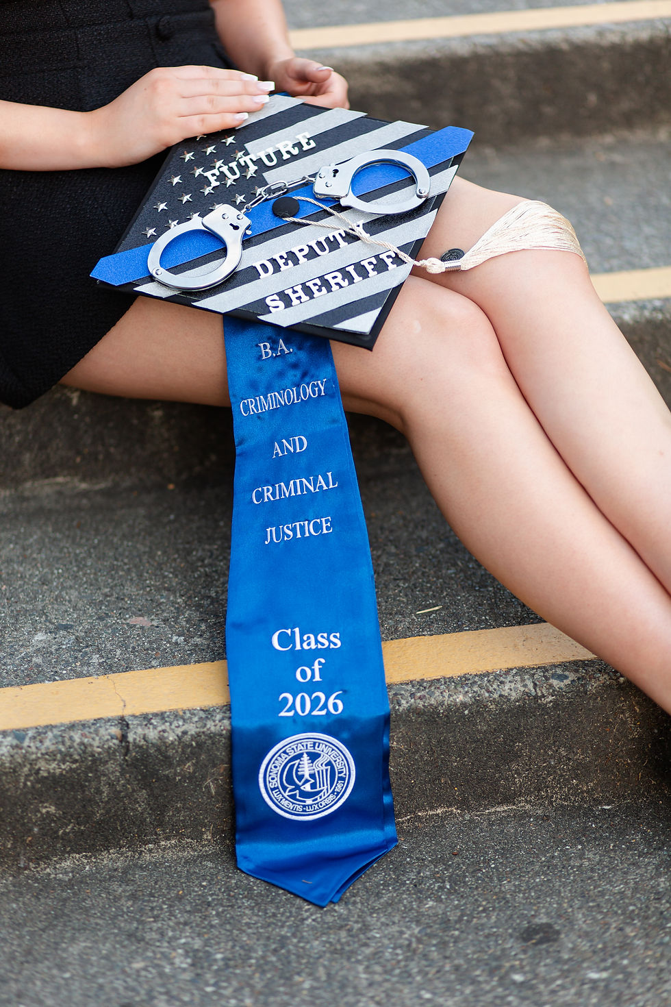 Graduation cap with handcuffs and ribbon reading Future Deputy Sheriff, B.A. Criminology and Criminal Justice.
College Grad photoshoot at Sonoma State University  by Bay Area Photographers HKCreate