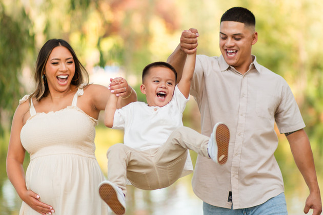 hkcreate bay area photography joyful candid light and airy san jose photographers northern california photoshoot
parents swinging little boy during family maternity session at vasona lake park, los gatos family of three