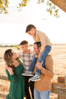 Coyote Lake Harvey Bear County Park photoshoot family location bay area photography hkcreate morgan hill mini session family of four green dress joyful laughing playful son on shoulders fence