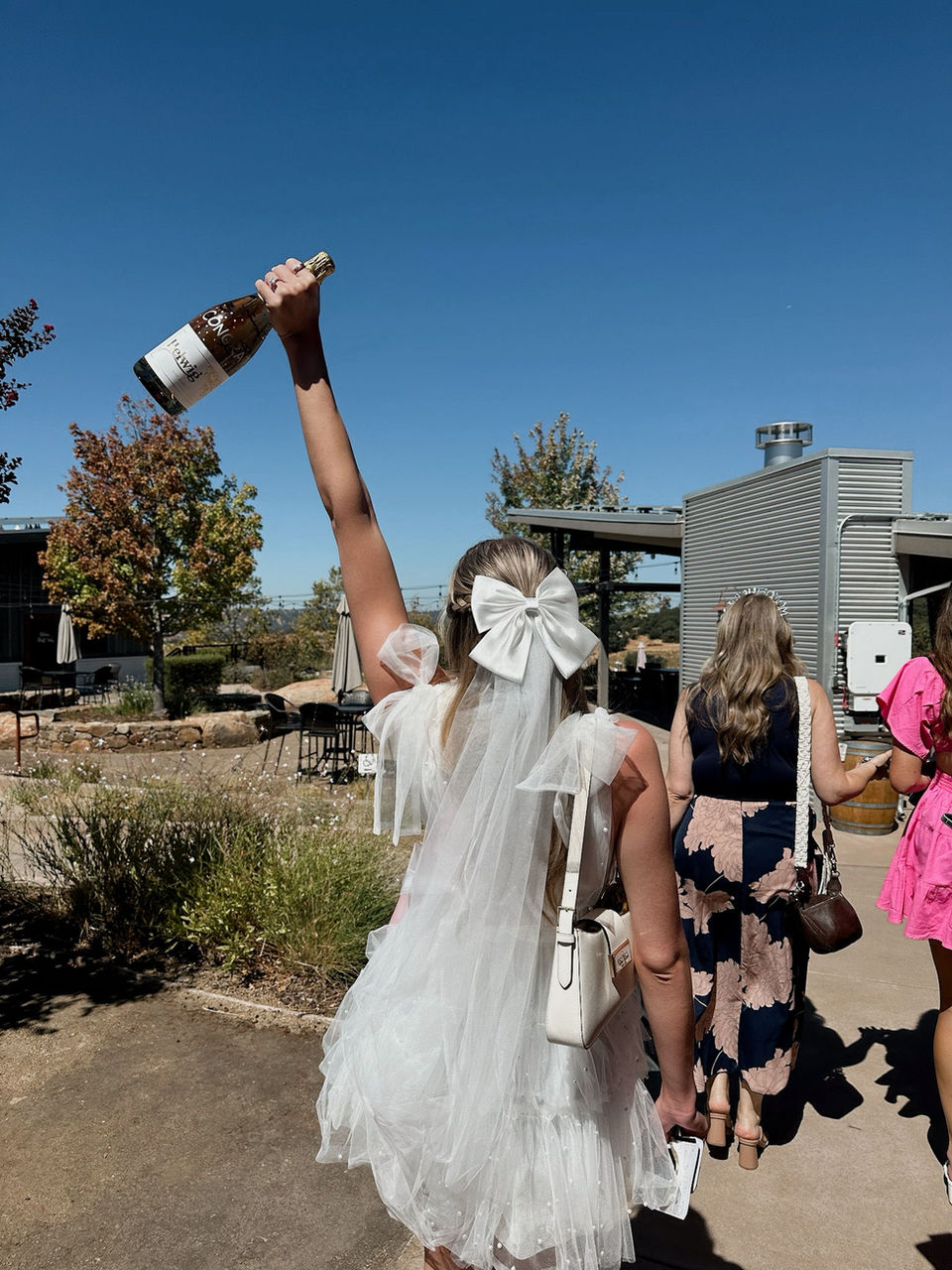 Bride-to-be celebrating with a bottle of wine at a Scottsdale bachelorette party
